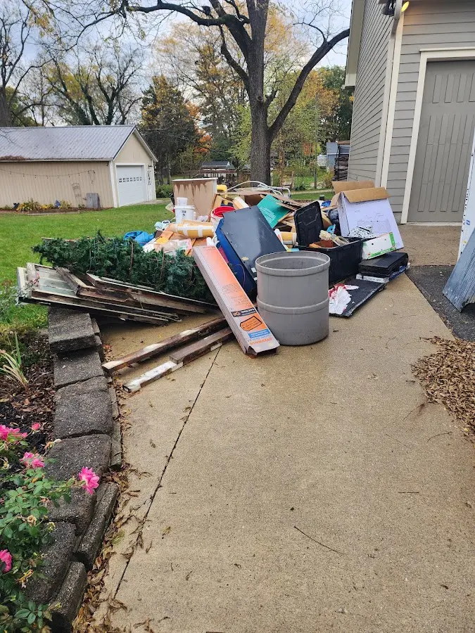 Dumpster being loaded with debris for Commercial Dumpster Rental in Bellaire